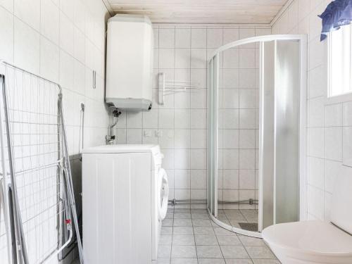 a white bathroom with a toilet and a shower at Holiday Home Gissarp Gryningen by Interhome in Nässjö