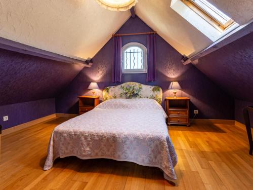 a bedroom with purple walls and a bed in a attic at Villa Villa Les Dunes by Interhome in Le Home Varaville