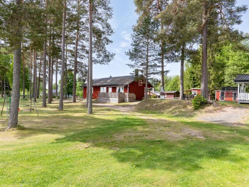 a red house in the woods with a yard at Holiday Home Gissarp Gryningen by Interhome in Nässjö
