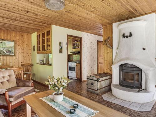 a living room with a fireplace in a house at Chalet Mjöhult Skogen - HAL022 by Interhome in Ätran