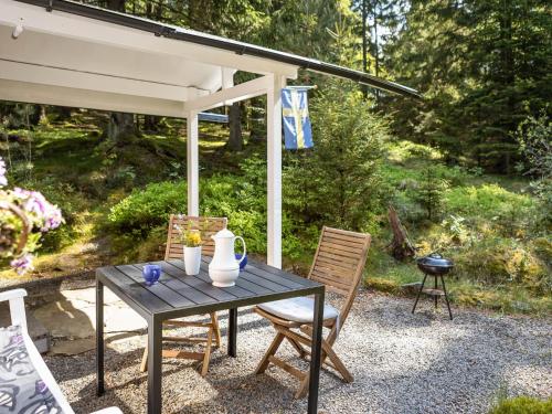 a black table and chairs under a pavilion at Holiday Home Dammeberg by Interhome in Karl Gustav