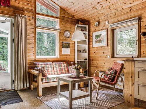 a living room with a table and a couch at Holiday Home Dammeberg by Interhome in Karl Gustav