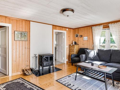 a living room with a couch and a table at Holiday Home Mjöhult Utsikten by Interhome in Ätran