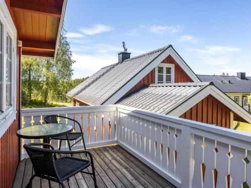 a balcony with chairs and a table and a house at Holiday Home Mjöhult Utsikten by Interhome in Ätran