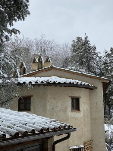 a house with snow on the roof of it at La Tana del Grifo - Podere Amodeo in Chiusi