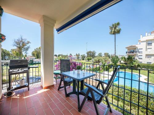 a patio with a table and chairs and a grill at Apartment Lorcrimar by Interhome in Marbella