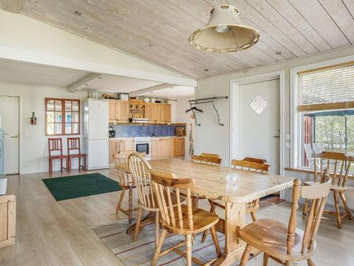 a kitchen with a wooden table and chairs at Holiday Home Ängasjö Ekbacken by Interhome in Östra Frölunda