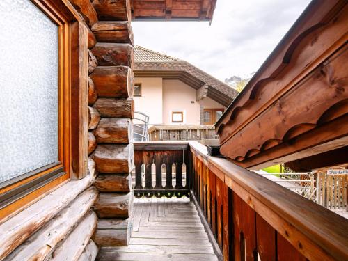 a wooden balcony of a house with a window at Apartment Cesa Pra da Molin-4 by Interhome in Campitello