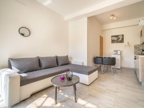 a living room with a couch and a table at Apartment Miškulin-4 by Interhome in Senj