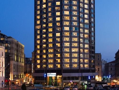 a tall building with many windows at night at The Marmara Pera in Istanbul
