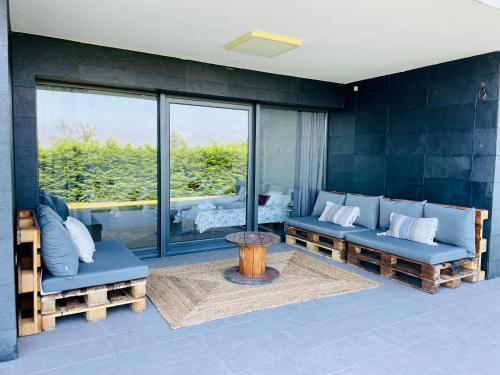 a living room with two blue couches and a table at Soleada in Gijón