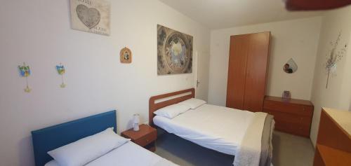 a small bedroom with two beds and a cabinet at CASA MAREA Appartamento 1 in Grottammare