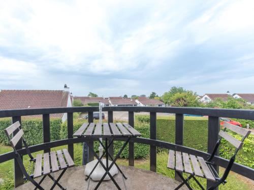 a balcony with two chairs and a table at Apartment La Bella Vita parking and shared pool by Interhome in De Haan