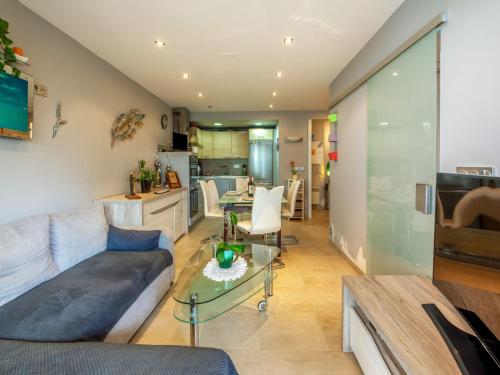 a living room with a couch and a table at Apartment Bidassoa by Interhome in Hendaye