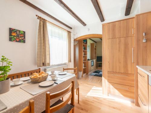 a kitchen and dining room with a table and chairs at Apartment Am Hohen Bogen-58 by Interhome in Kummersdorf