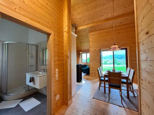 a dining room and kitchen with a table and a sink at Chalet Stressless by Interhome in Presseggen