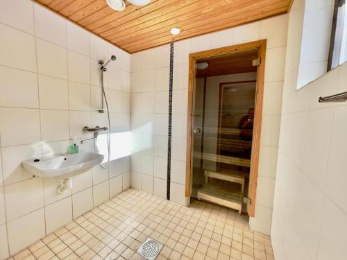 a bathroom with a shower and a sink at Apartment Kalliokuja in Pyhäjoki