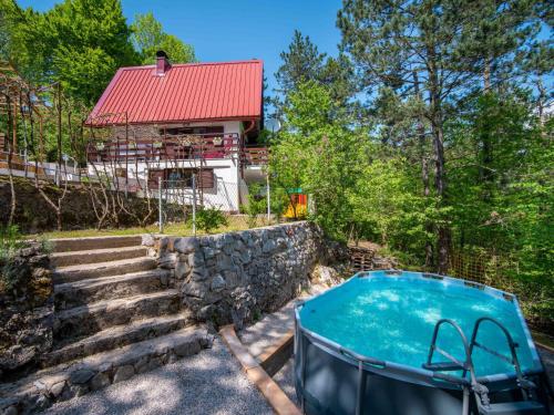 a house with a hot tub in the yard at Chalet Nina by Interhome in Lič