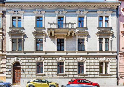 two cars parked in front of a building at Bentis Luxury Apartments in Kraków