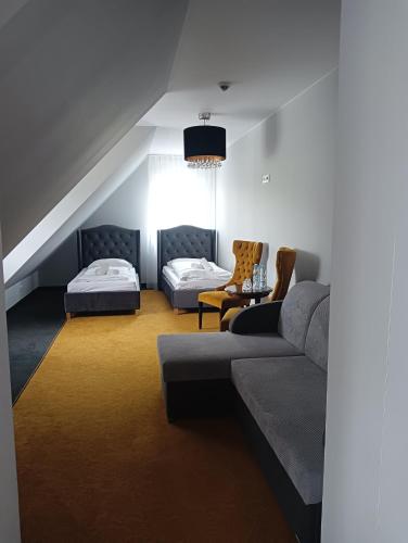 a living room with a couch and a bed at Pałac na Wodzie Hotel & SPA in Jelenia Góra