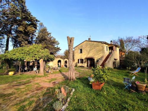 an old house with a tree in the yard at Apartment La Pergola by Interhome in Roccastrada