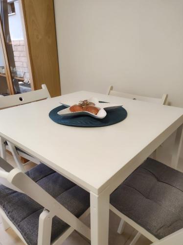 a white table with chairs and a mouse on it at Casa vacanze Marinella in Santo Stefano al Mare