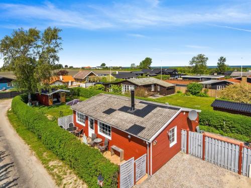 an overhead view of a red house with a yard at Holiday Home Amy - 150m from the sea in Funen by Interhome in Otterup