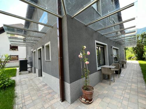 an enclosed patio with a table and a plant at Panorama rooms in Bovec