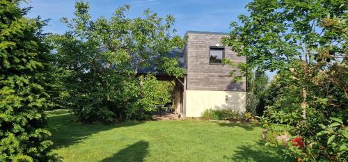 a brick house with a yard with trees at La Meausserie in La Mausserie