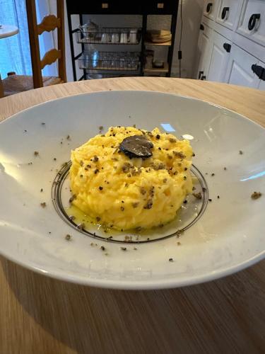 a white plate with food on a table at L'instant d'un séjour in Le Guâ