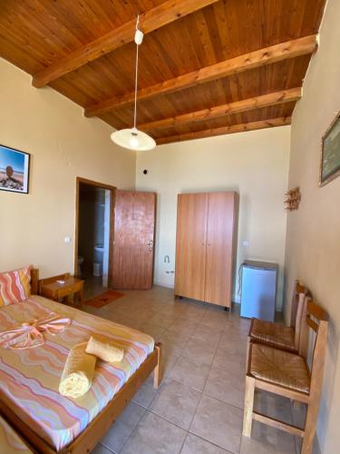 a bedroom with a bed and a chair in a room at Gavdos Panorama in Gavdos