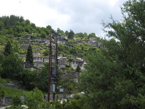 a mountain with houses on a hill with trees at Melinas Boutique Hotel B&B in Kipoi