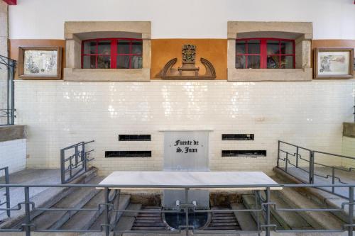 a stage in a building with red windows at Iberik Gran Balneario de Guitiriz in Guitiriz
