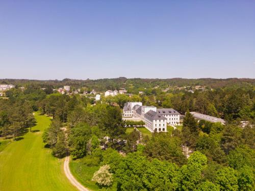 an aerial view of a house in a green field at Iberik Gran Balneario de Guitiriz in Guitiriz