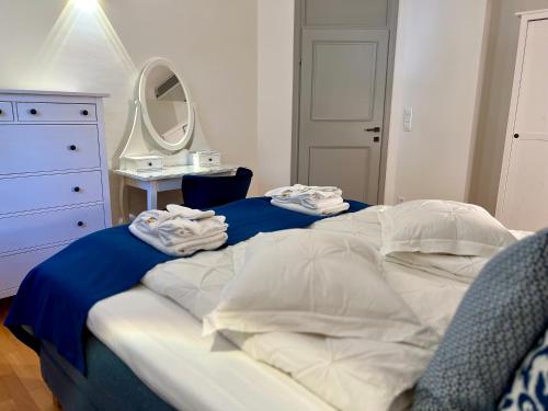 a bedroom with a bed with blue sheets and a mirror at Villa Romana II Omis in Omiš