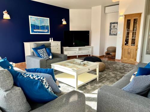 a living room with two couches and a tv at Villa Romana II Omis in Omiš