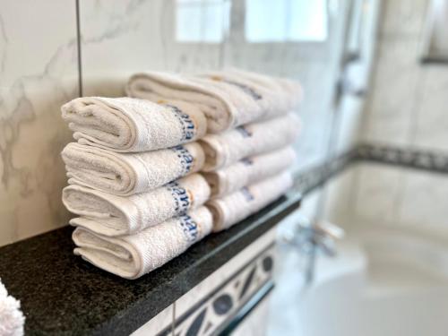 a stack of towels on a counter in a bathroom at Villa Romana II Omis in Omiš