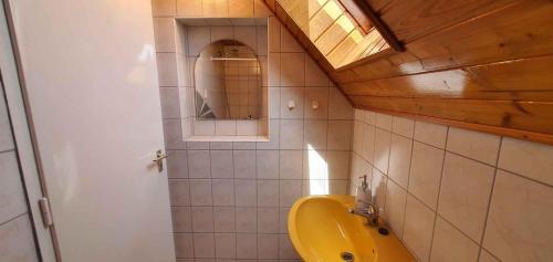 バラトンフェニヴェシュにあるApartment Balatonfenyves/Balaton 18389のバスルーム(黄色の洗面台、鏡付)