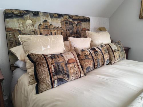 a group of pillows on a bed in a room at Divine Cottage in Ballycastle