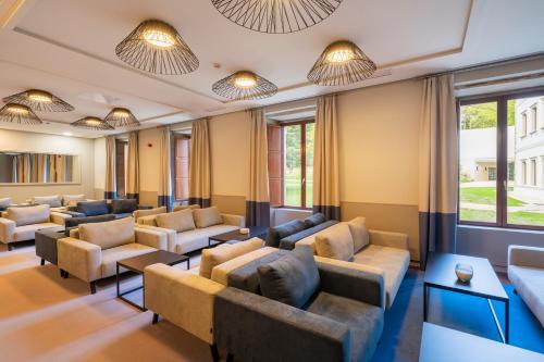 a waiting room with couches and chairs at Iberik Gran Balneario de Guitiriz in Guitiriz
