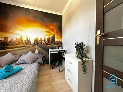 a bedroom with a city skyline mural on the wall at Zupka room in Gdańsk