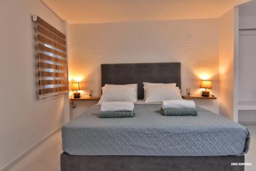 a bedroom with a large bed with two pillows at Sisi seaview apartments in Sisi