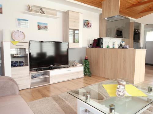 a living room with a flat screen tv on a table at Apartment Strandkorb by Interhome in Hooksiel