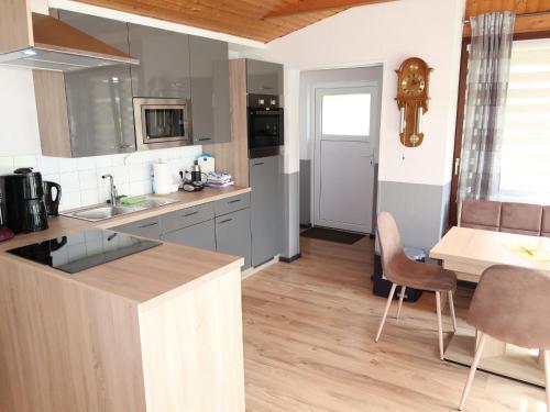 a kitchen with a counter and a table with chairs at Apartment Strandkorb by Interhome in Hooksiel