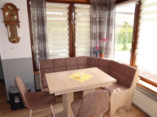 a table and chairs in a room with a couch at Apartment Strandkorb by Interhome in Hooksiel