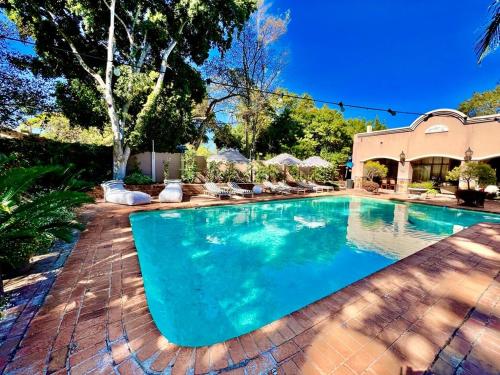 a swimming pool in a yard with a house at Forty 4 On Hoog in Polokwane