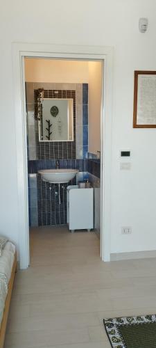 a bathroom with a sink and a mirror at L'angolo degli ulivi in Marcellano