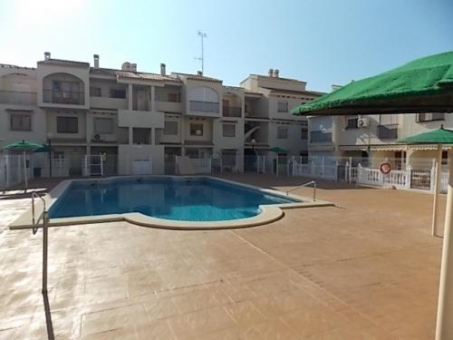 a large swimming pool in front of a building at Duplex Puertosol in Puerto de Mazarrón