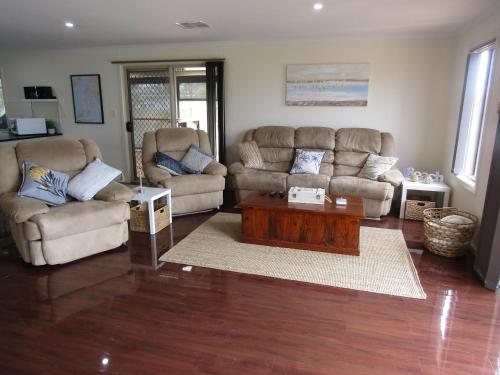 a living room with two couches and a coffee table at The Shack at Vincent in Port Vincent