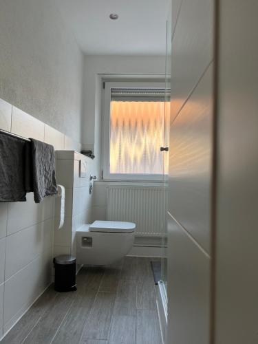 a bathroom with a toilet and a window at Apartment in Weiden i. d. Opf. in Weiden